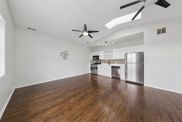 519 S Maplewood Ave Unit 4S, Chicago, IL 60612 - unfurnished living room with a ceiling fan, vaulted ceiling, a skylight, dark wood-type flooring, and a sink