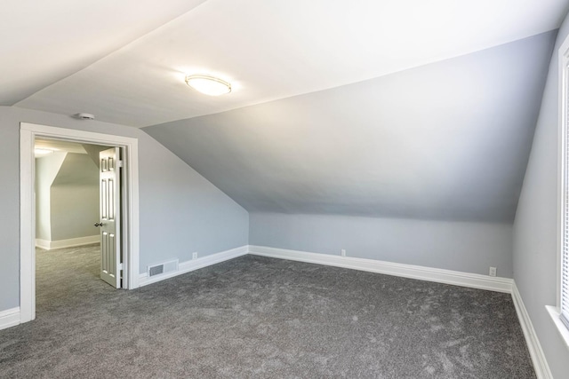 14446 Martin Luther King Jr Dr, Dolton, IL 60419 - additional living space featuring dark colored carpet, lofted ceiling, and baseboards