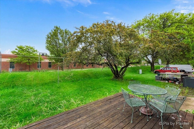 405 S Belmont Ave, Elgin, IL 60123 - wooden terrace with outdoor dining area, a yard, and central AC