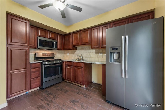 405 S Belmont Ave, Elgin, IL 60123 - kitchen featuring appliances with stainless steel finishes, backsplash, a ceiling fan, light stone counters, and a sink