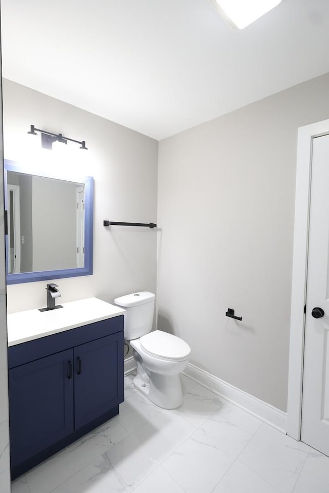 16456 Dobson Ave, South Holland, IL 60473 - bathroom featuring marble look tiles, vanity, baseboards, and toilet