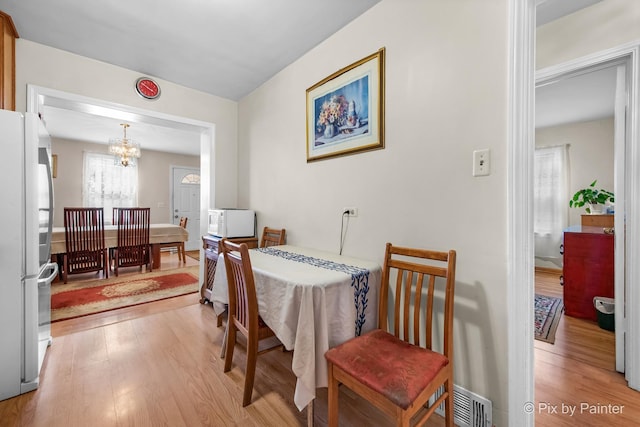 3324 N Ottawa Ave, Chicago, IL 60634 - dining room featuring a chandelier and light wood-style floors