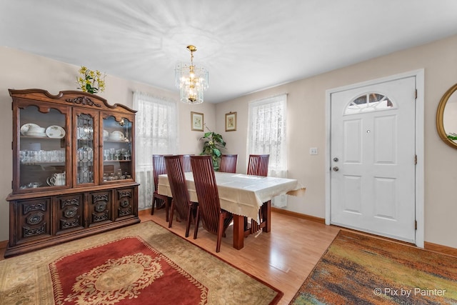 3324 N Ottawa Ave, Chicago, IL 60634 - dining room with healthy amount of natural light, a chandelier, and light wood-style flooring