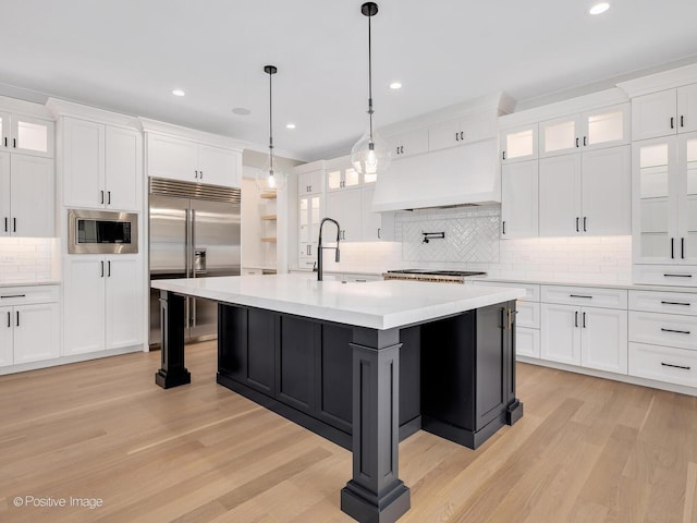 435 S W Ave, Elmhurst, IL 60126 - kitchen with built in appliances, premium range hood, a sink, decorative backsplash, and light countertops
