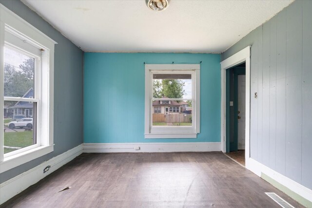 2007 3x Ave, East Moline, IL 61244 - unfurnished room featuring wood finished floors, baseboards, and wood walls