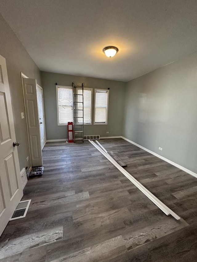 4942 S Racine Ave, Chicago, IL 60609 - unfurnished room with dark wood-type flooring and baseboards