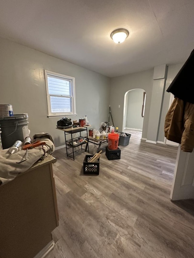 4942 S Racine Ave, Chicago, IL 60609 - recreation room featuring arched walkways, baseboards, and wood finished floors