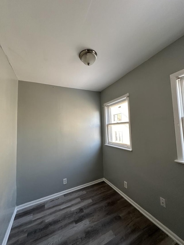 4942 S Racine Ave, Chicago, IL 60609 - unfurnished room with dark wood-style flooring and baseboards