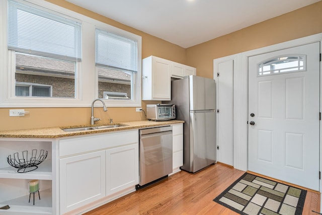 1627 S 14th Ave, Maywood, IL 60153 - kitchen featuring stainless steel appliances, light wood-style floors, white cabinetry, and light stone countertops