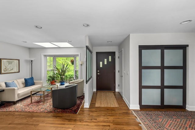 1101 Oak St, Winnetka, IL 60093 - living area featuring wood finished floors, a skylight, baseboards, and recessed lighting
