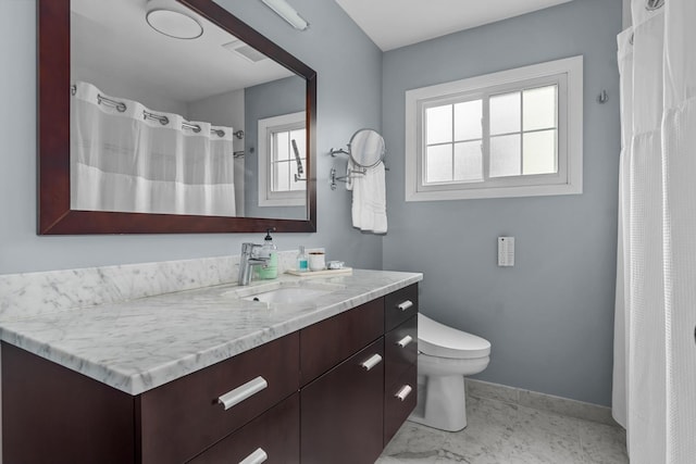 1101 Oak St, Winnetka, IL 60093 - bathroom with vanity, toilet, healthy amount of natural light, and baseboards