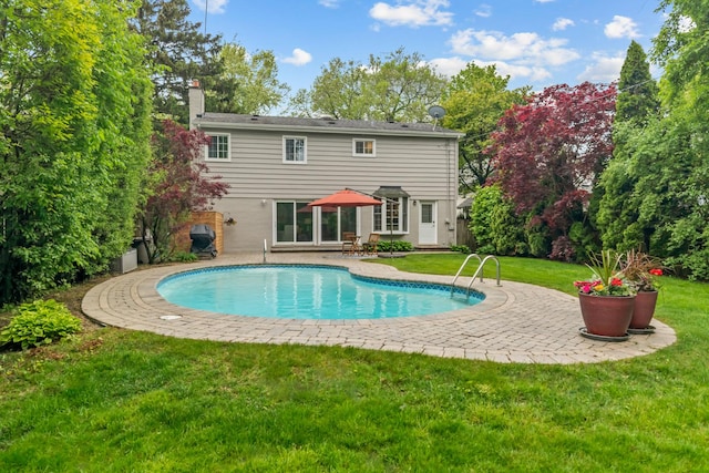1101 Oak St, Winnetka, IL 60093 - back of house featuring a patio, an outdoor pool, a yard, and a chimney