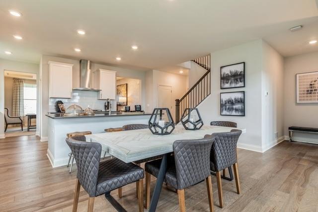 213 Rhinebeck Way, Algonquin, IL 60102 - dining area featuring baseboards, light wood finished floors, stairs, and recessed lighting