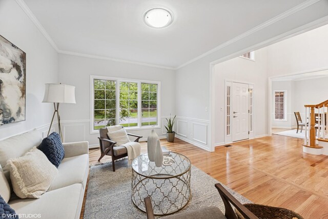 1040 E Buckingham Dr, Naperville, IL 60563 - living area with light wood finished floors, ornamental molding, and a wainscoted wall