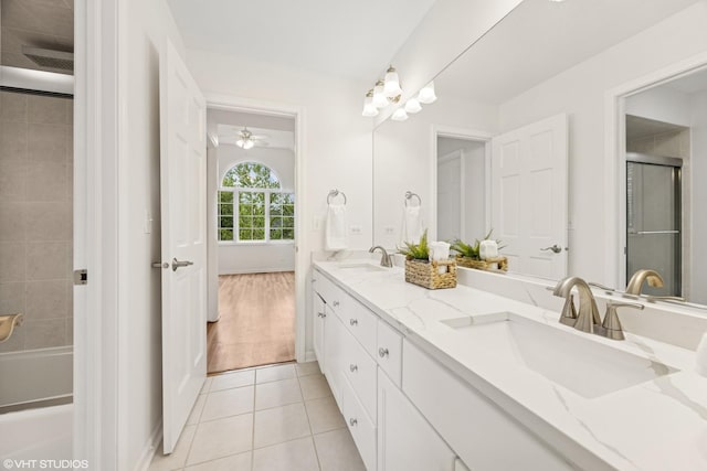 1040 E Buckingham Dr, Naperville, IL 60563 - full bathroom featuring double vanity, tile patterned flooring, ceiling fan, baseboards, and shower / washtub combination