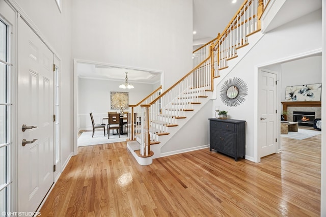 1040 E Buckingham Dr, Naperville, IL 60563 - entrance foyer with stairs, a high ceiling, baseboards, wood finished floors, and a chandelier