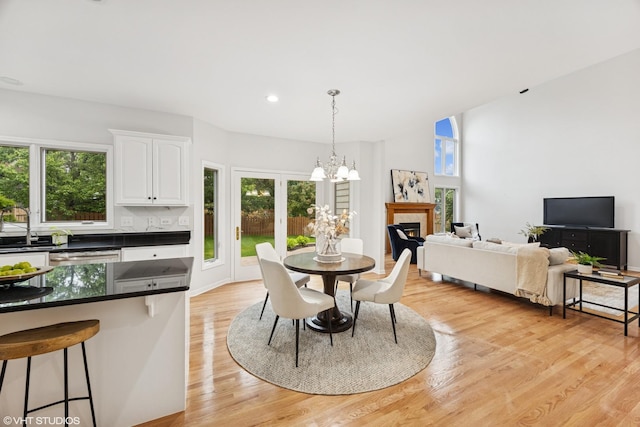 1040 E Buckingham Dr, Naperville, IL 60563 - dining room with healthy amount of natural light, a chandelier, light wood-style floors, and recessed lighting