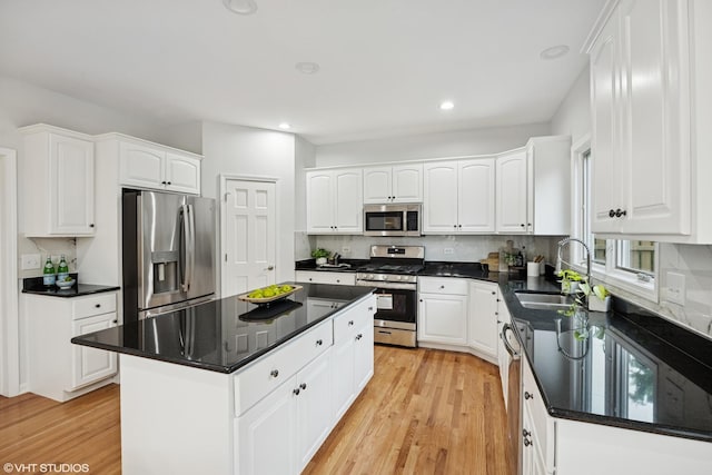 1040 E Buckingham Dr, Naperville, IL 60563 - kitchen with appliances with stainless steel finishes, a sink, light wood-style flooring, white cabinetry, and a kitchen island