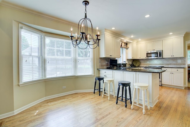1056 Whirlaway Ave, Naperville, IL 60540 - kitchen featuring stainless steel appliances, a chandelier, baseboards, healthy amount of natural light, and crown molding