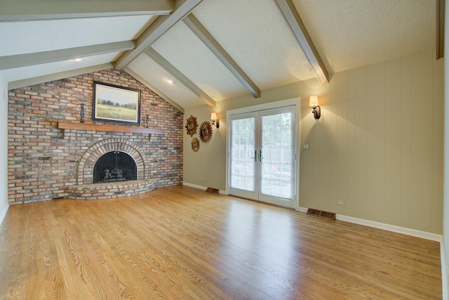 1056 Whirlaway Ave, Naperville, IL 60540 - unfurnished living room featuring wood finished floors, a fireplace, french doors, and a textured ceiling