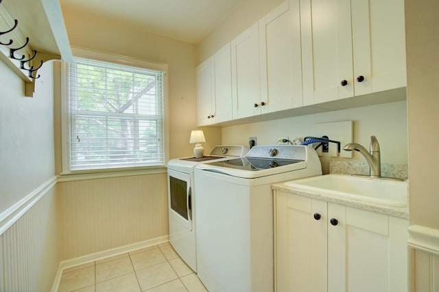 1056 Whirlaway Ave, Naperville, IL 60540 - laundry room with washer and dryer, cabinet space, light tile patterned floors, a wainscoted wall, and baseboards