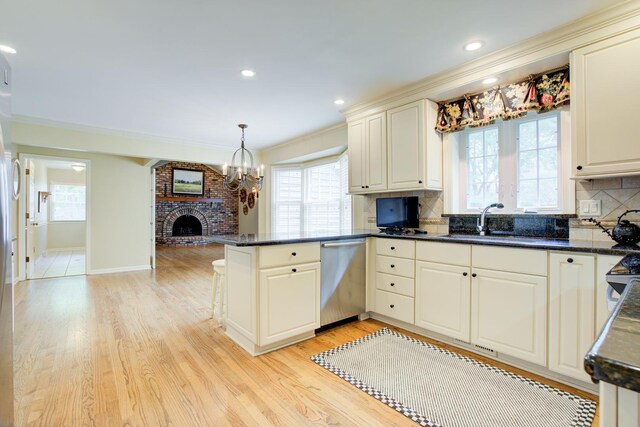 1056 Whirlaway Ave, Naperville, IL 60540 - kitchen with dishwasher, a peninsula, a sink, light wood-style flooring, and backsplash