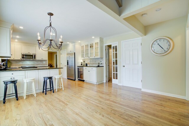 1056 Whirlaway Ave, Naperville, IL 60540 - kitchen featuring appliances with stainless steel finishes, wine cooler, dark countertops, decorative backsplash, and recessed lighting