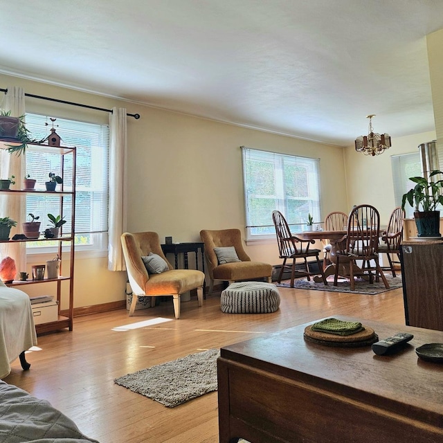 130 First St, Cary, IL 60013 - living room with a chandelier, wood finished floors, baseboards, and crown molding