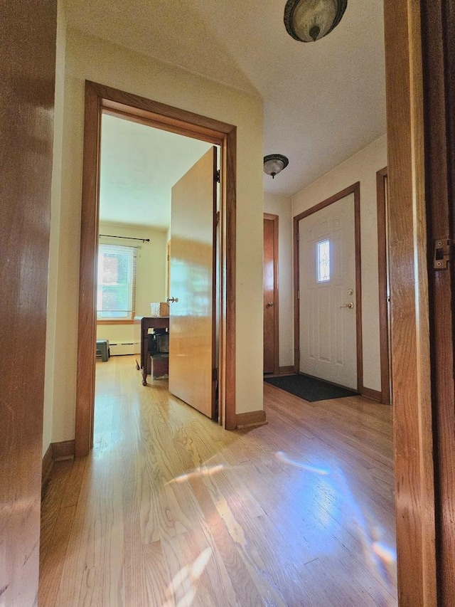 130 First St, Cary, IL 60013 - hall with a baseboard heating unit, light wood-style flooring, healthy amount of natural light, and baseboards