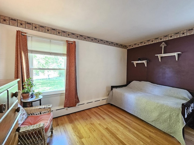 130 First St, Cary, IL 60013 - bedroom featuring wood finished floors, a baseboard heating unit, and baseboards