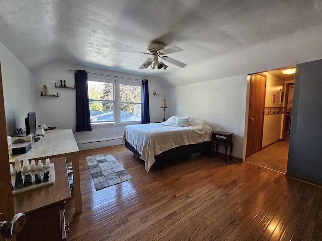 130 First St, Cary, IL 60013 - bedroom with a baseboard radiator, lofted ceiling, hardwood / wood-style flooring, a textured ceiling, and baseboards