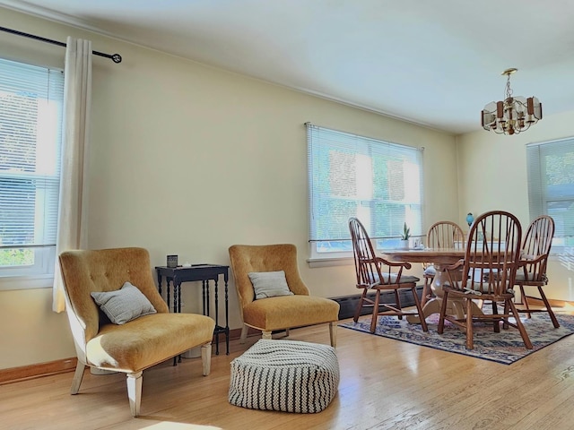 130 First St, Cary, IL 60013 - dining room featuring a chandelier, wood finished floors, baseboards, and baseboard heating