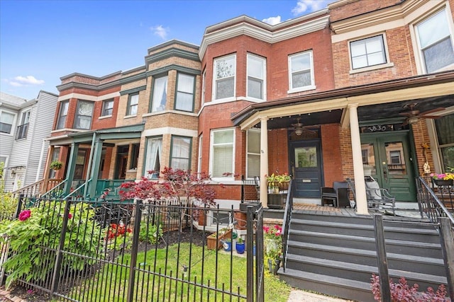 3828 N Wilton Ave, Chicago, IL 60613 - view of property with covered porch, brick siding, a fenced front yard, and a ceiling fan