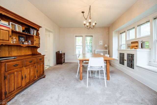 456 S Indiana Ave, Kankakee, IL 60901 - dining space with a chandelier, light colored carpet, and baseboards