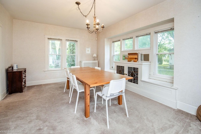 456 S Indiana Ave, Kankakee, IL 60901 - dining area with a chandelier, baseboards, light carpet, and a tile fireplace