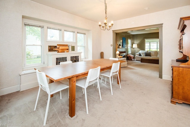456 S Indiana Ave, Kankakee, IL 60901 - dining space with a chandelier, light carpet, and baseboards