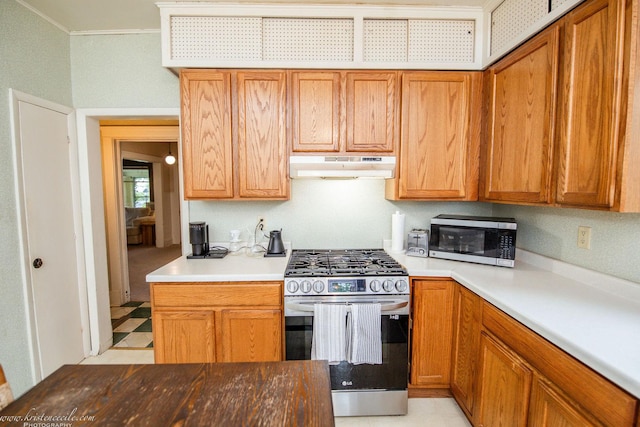 456 S Indiana Ave, Kankakee, IL 60901 - kitchen with stainless steel appliances, under cabinet range hood, ornamental molding, brown cabinets, and light countertops