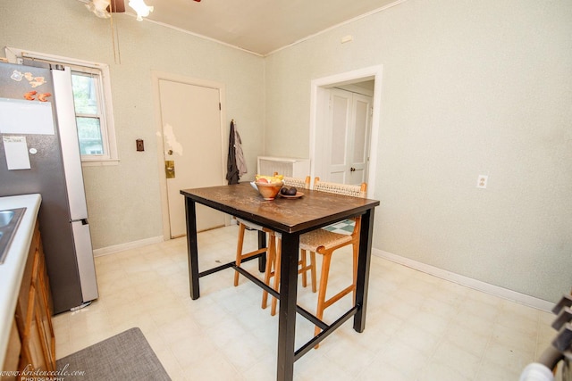 456 S Indiana Ave, Kankakee, IL 60901 - kitchen with light floors, freestanding refrigerator, crown molding, a ceiling fan, and baseboards