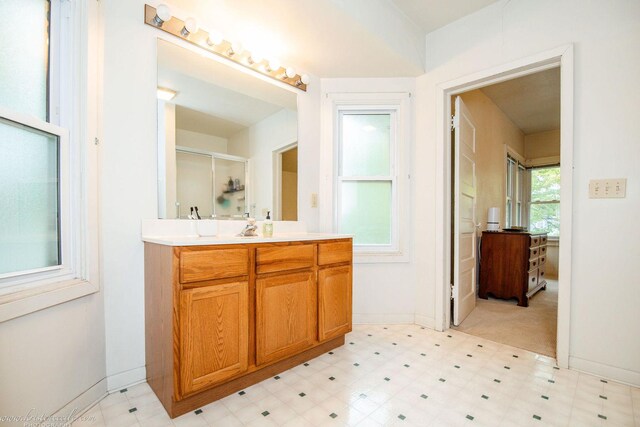456 S Indiana Ave, Kankakee, IL 60901 - bathroom with tile patterned floors, vanity, a shower stall, and baseboards