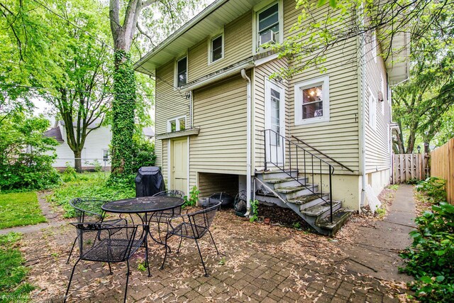 456 S Indiana Ave, Kankakee, IL 60901 - rear view of property featuring entry steps, a patio, and cooling unit