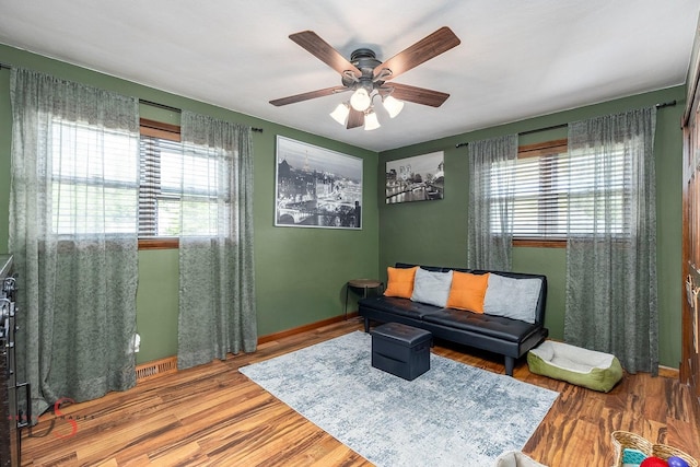 907 Parks Ln, Ottawa, IL 61350 - living area with plenty of natural light, a ceiling fan, wood finished floors, and baseboards
