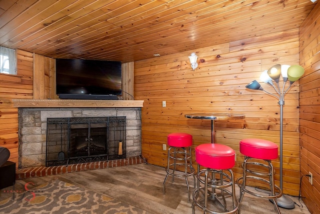 907 Parks Ln, Ottawa, IL 61350 - dining area with wood walls, wooden ceiling, wood finished floors, and a stone fireplace