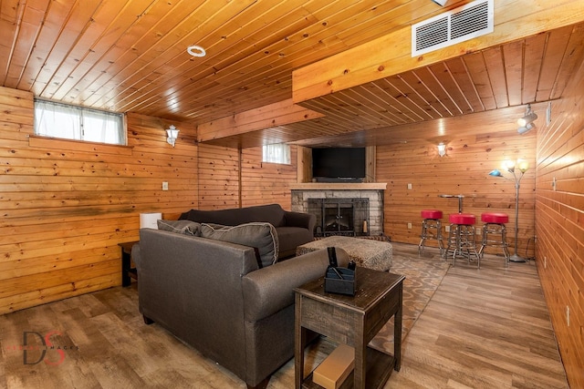 907 Parks Ln, Ottawa, IL 61350 - living area with wooden ceiling, wood walls, a stone fireplace, and wood finished floors