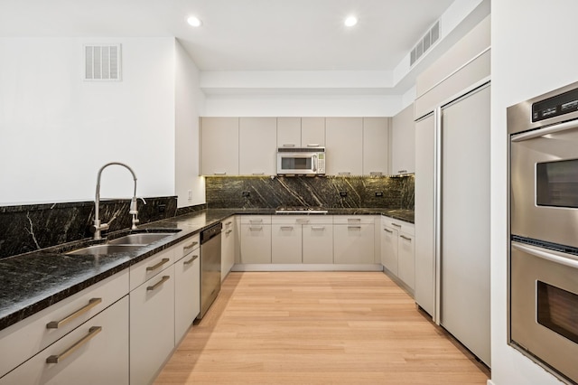 500 W Superior St Unit 805, Chicago, IL 60654 - kitchen featuring stainless steel appliances, a sink, light wood-style flooring, recessed lighting, and backsplash