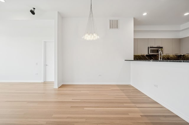 500 W Superior St Unit 805, Chicago, IL 60654 - unfurnished dining area with light wood finished floors, recessed lighting, baseboards, and a chandelier