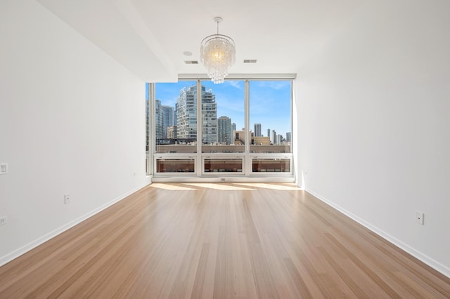 500 W Superior St Unit 805, Chicago, IL 60654 - unfurnished dining area featuring a chandelier, a skyline view, wood finished floors, baseboards, and expansive windows