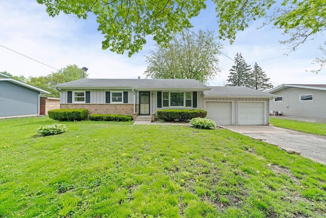 119 Cook Ct, Somonauk, IL 60552 - single story home with an attached garage, concrete driveway, a front lawn, board and batten siding, and brick siding