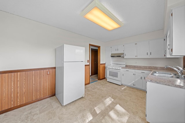 119 Cook Ct, Somonauk, IL 60552 - kitchen featuring white appliances, a sink, under cabinet range hood, wainscoting, and white cabinetry
