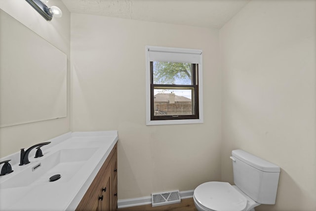 119 Cook Ct, Somonauk, IL 60552 - bathroom with toilet, vanity, baseboards, and wood finished floors