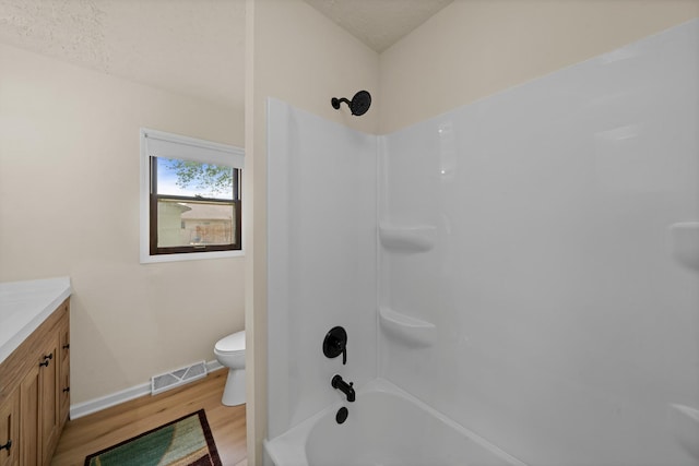119 Cook Ct, Somonauk, IL 60552 - full bath with wood finished floors, toilet, vanity, bathing tub / shower combination, and baseboards